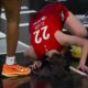Caitlin Clark down on the ground in pain