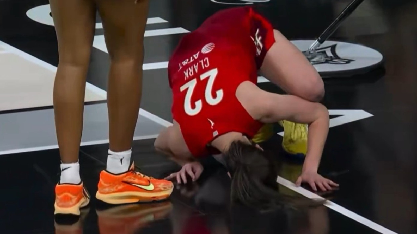 Caitlin Clark down on the ground in pain