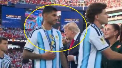 Cristian Romero walking past Donald Trump