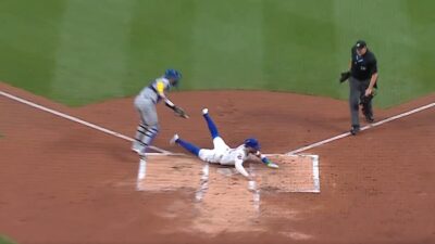 A New York Mets runner sliding into home plate