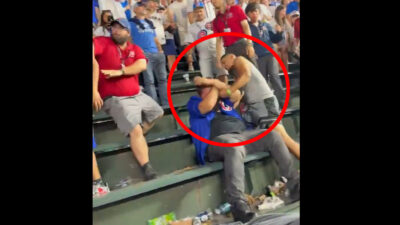 A Cubs fan gets punched in the head during a fight