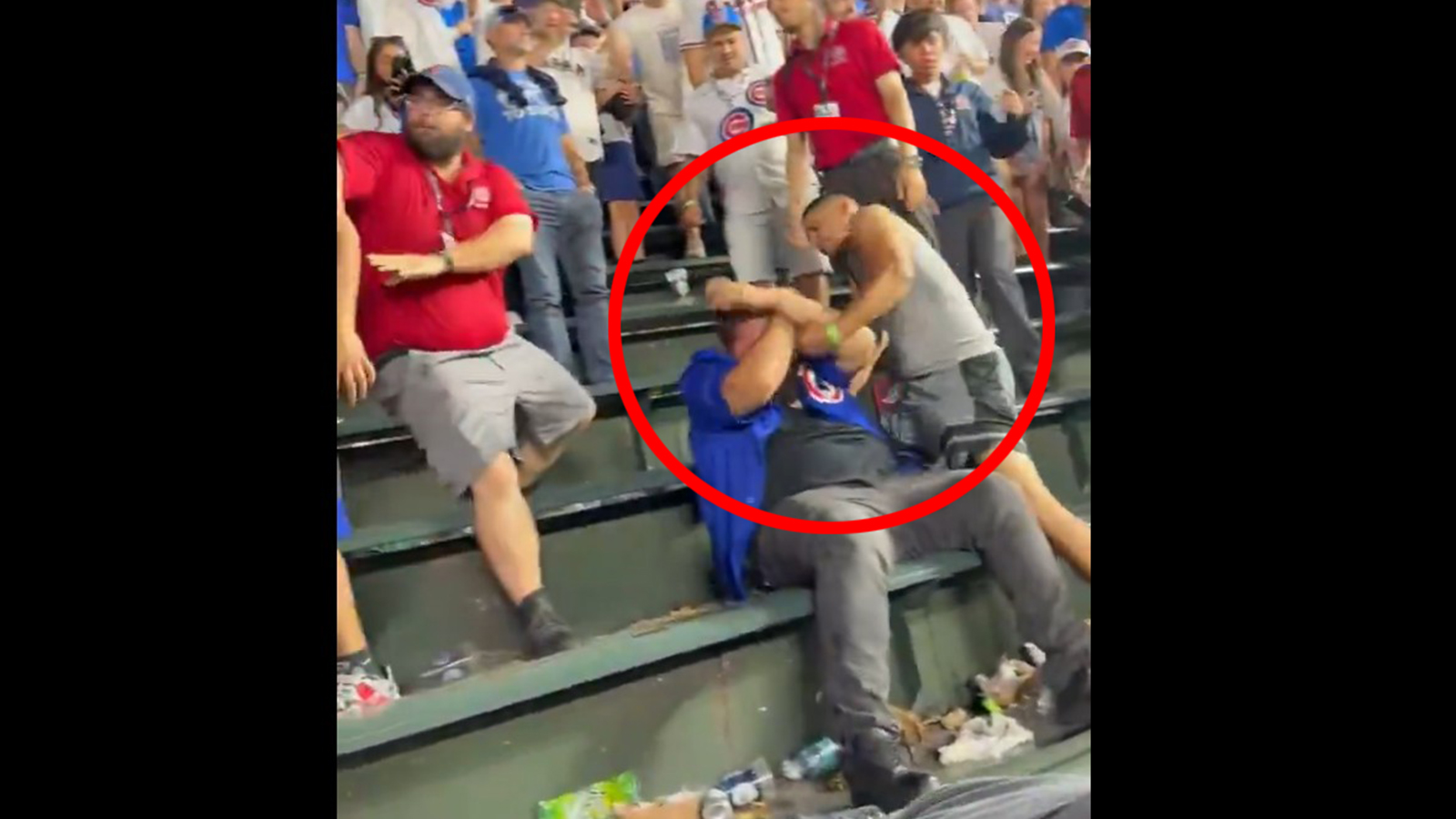 A Cubs fan gets punched in the head during a fight