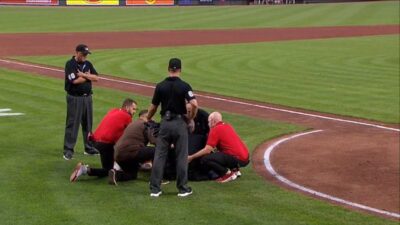 Manny Gonzalez being surrounded by trainers