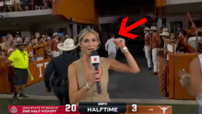 Laura Rutledge holding a mic as Steve Sarkisian runs in the background