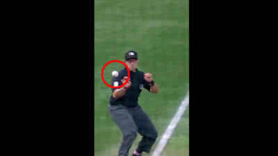 MLB umpire Alex MacKay gets out of the way of a foul ball