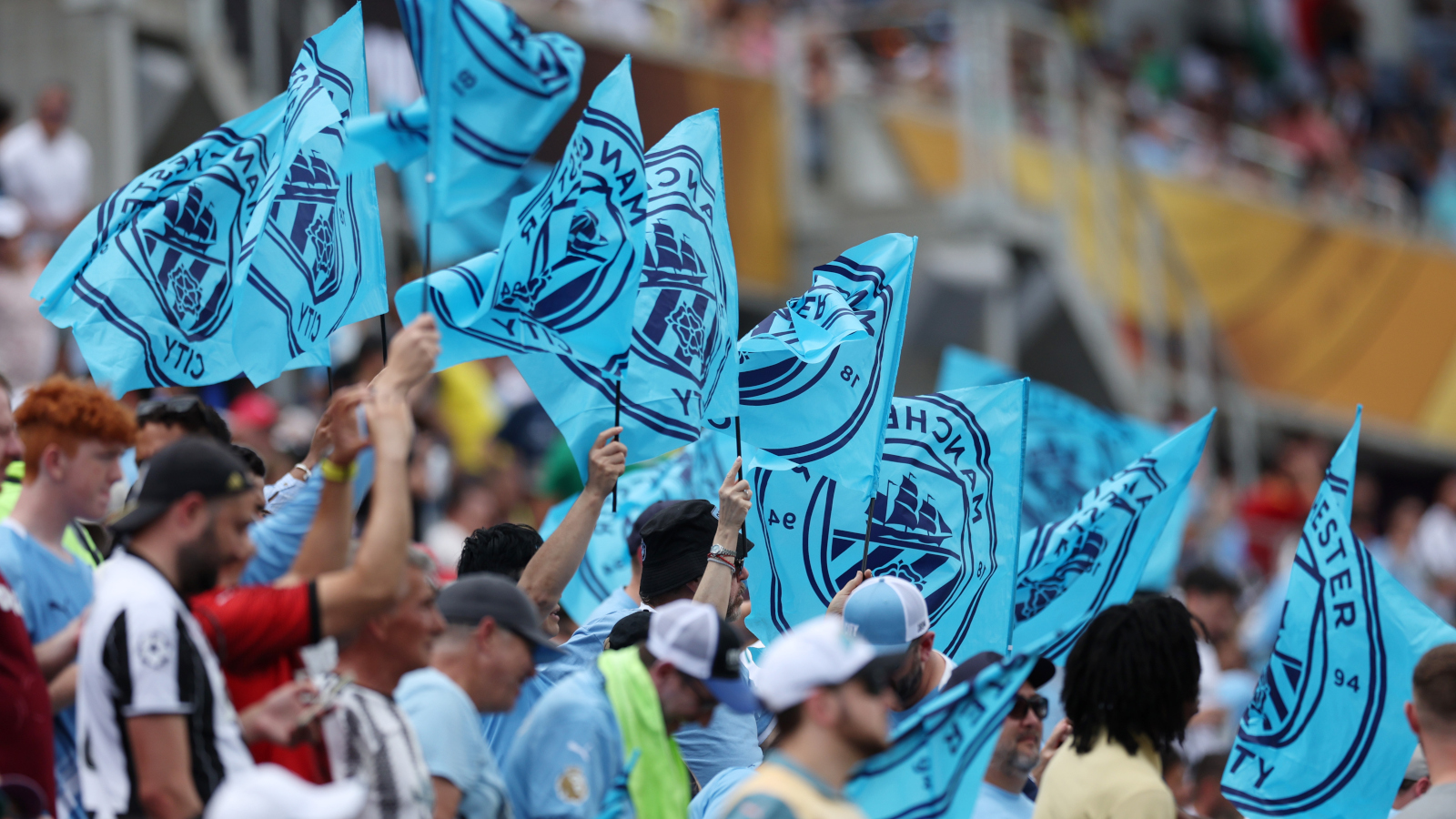 Manchester City fans wave flags.