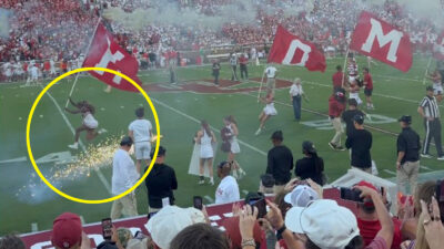 Oklahoma cheerleader dodging a loose firework
