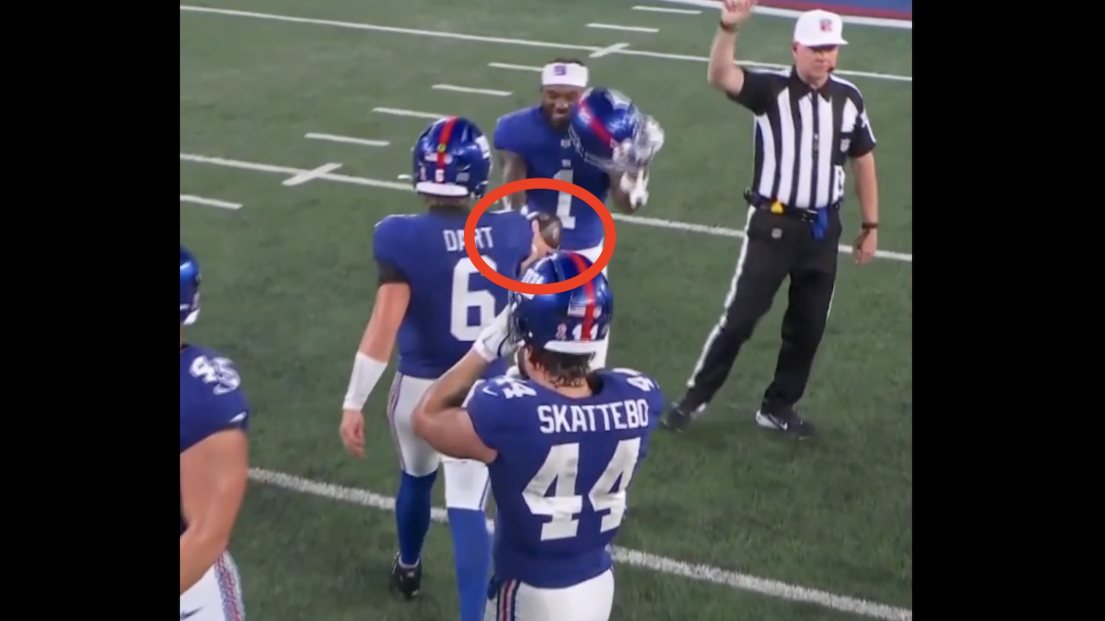 Jaxson Dart handing the game ball to Malik Nabers after Giants beat Cowboys