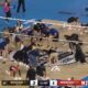 Volleyball players wipe the court during event at Wrigley Field