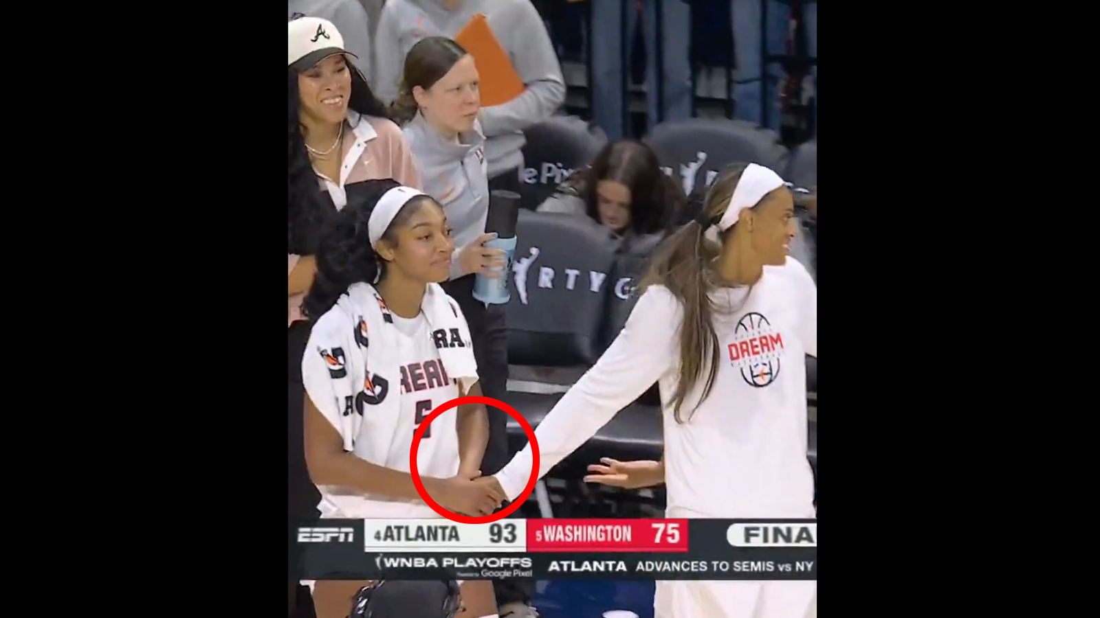DeWanne Bonner holding Angel Reese's hand