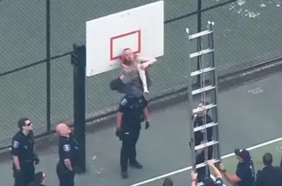 Guy pants stuck basketball hoop
