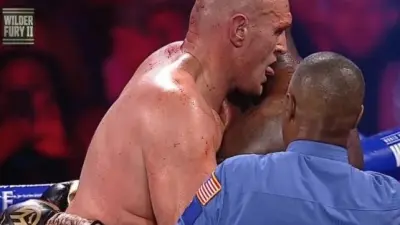 Tyson Fury licks Deontay Wilder