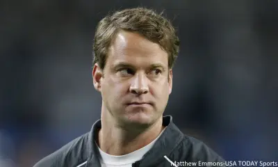 Lane Kiffin looks on