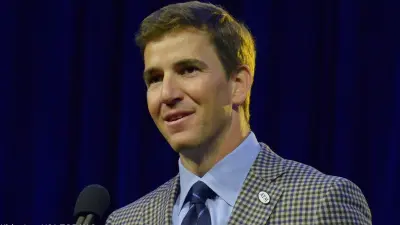 Eli Manning in a coat and tie