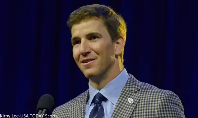 Eli Manning in a coat and tie