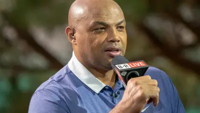 Charles Barkley holds a microphone