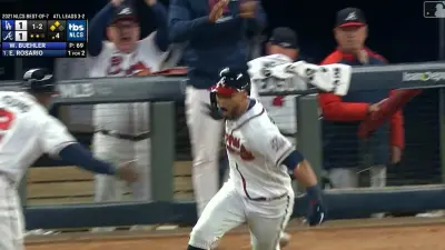 Eddie Rosario rounds first base
