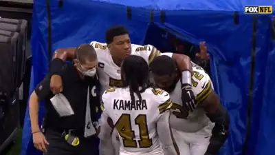 Jameis Winston being helped off the field