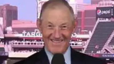 Jim Kaat holds a microphone