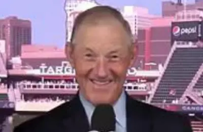 Jim Kaat holds a microphone
