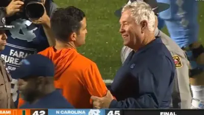 Mack Brown shakes Manny Diaz hand