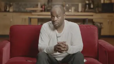 Roy Johnson sits on a couch
