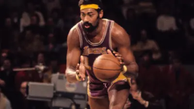 Wilt Chamberlain dribbles the ball