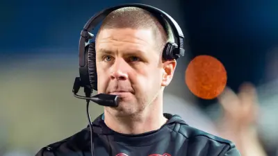 Billy Napier wearing a headset