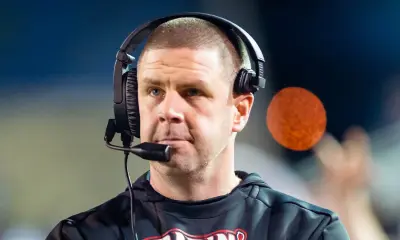 Billy Napier wearing a headset