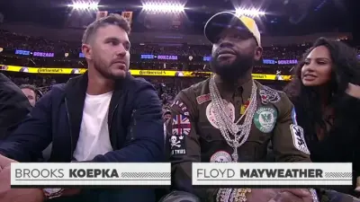 Brooks Koepka seated next to Floyd Mayweather