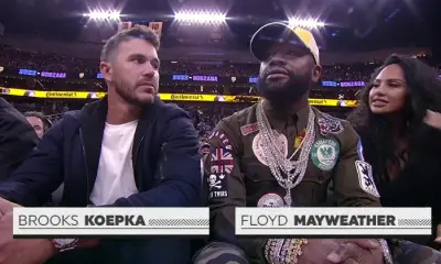 Brooks Koepka seated next to Floyd Mayweather