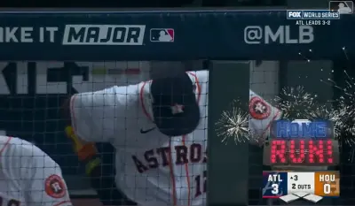 Dusty Baker with his head down in the dugout