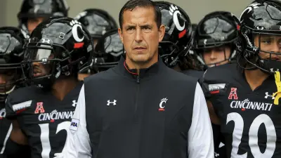 Luke Fickell stands in front of his players