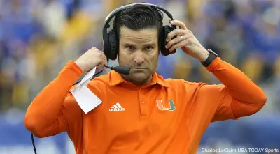 Manny Diaz adjusts his headset