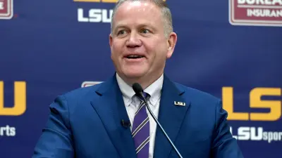 Brian Kelly smiles at an LSU press conference
