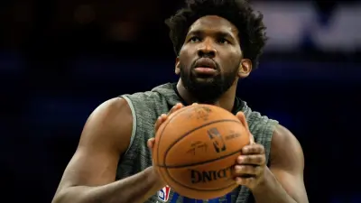 Joel Embiid holds a basketball