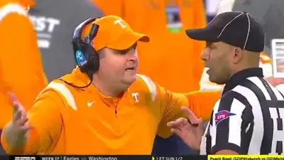 Josh Heupel talks with a ref