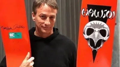 Tony Hawk holds a skateboard