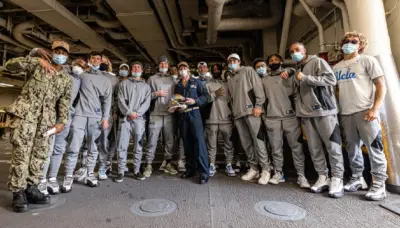 UCLA players on a naval ship