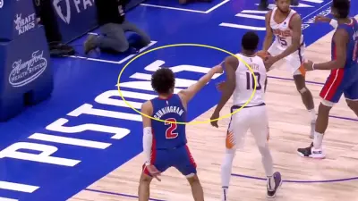 Cade Cunningham points at the bench