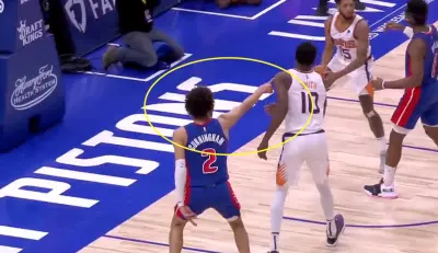 Cade Cunningham points at the bench