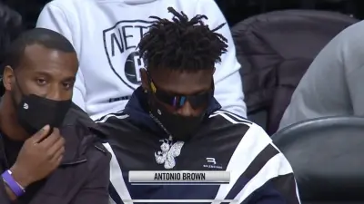 Antonio Brown sitting courtside