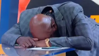 James Worthy hunched over a desk