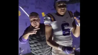 Brian Kelly dances with a recruit