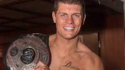 Cody Rhodes holds a championship belt