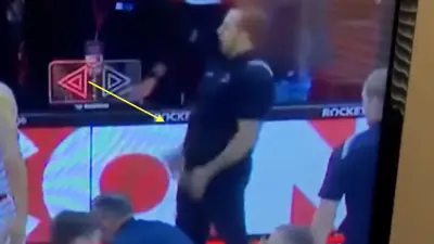 A Wisconsin staffer makes a crude gesture