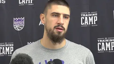 Alex Len talks with the media