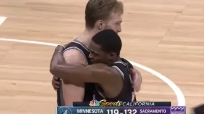 DeAaron Fox hugs Domantas Sabonis