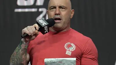 Joe Rogan holds a mic