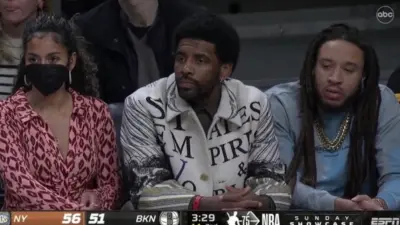Kyrie Irving sits courtside